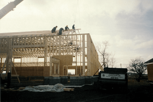 A group of men working on the roof of a building.