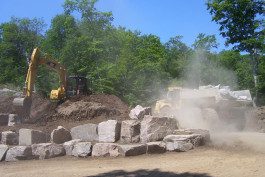 A large pile of rocks being loaded with dirt.