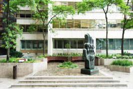 A statue of a hand in the middle of a courtyard.