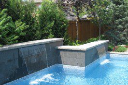 A swimming pool with a waterfall in the middle.