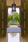 A doorway leading to a courtyard with a fountain.