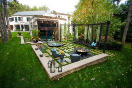 A large backyard with a fire pit and patio furniture.