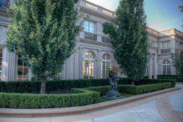 An ornate mansion with trees in front of it.