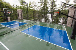 A basketball court with trees in the background.