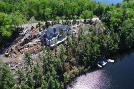 A large house sitting on top of a lake.