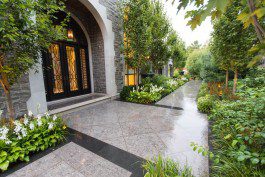 A large stone walkway leading to the front door of a house.