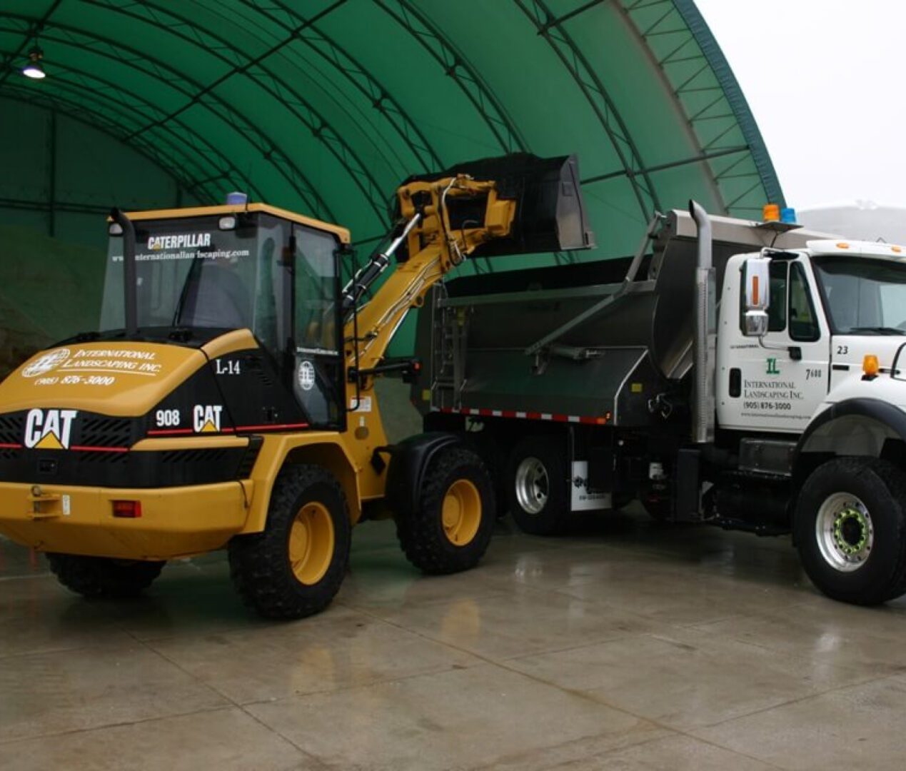 A white truck with a plow in the back.